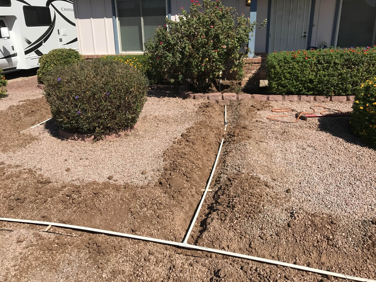 Landscape consultants laying out irrigation plan for home.