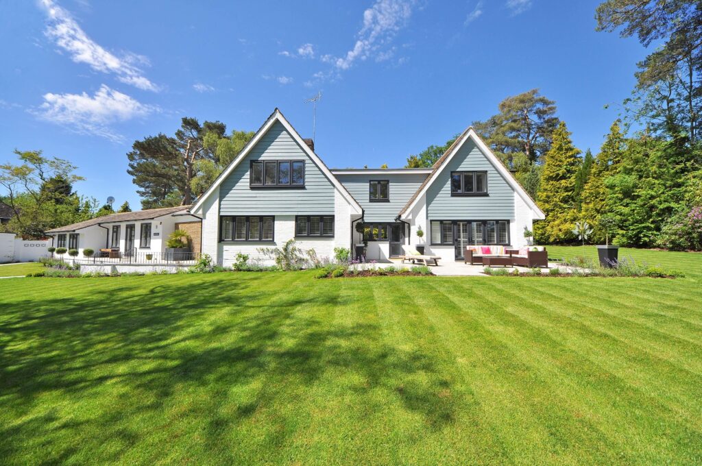 Manicured lawn in front of a large home.