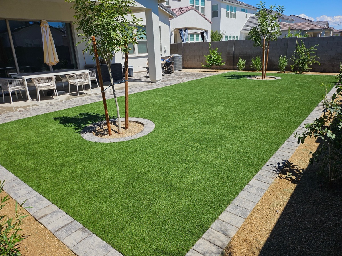 Core Landscape installation showing turf, trees, and pavers